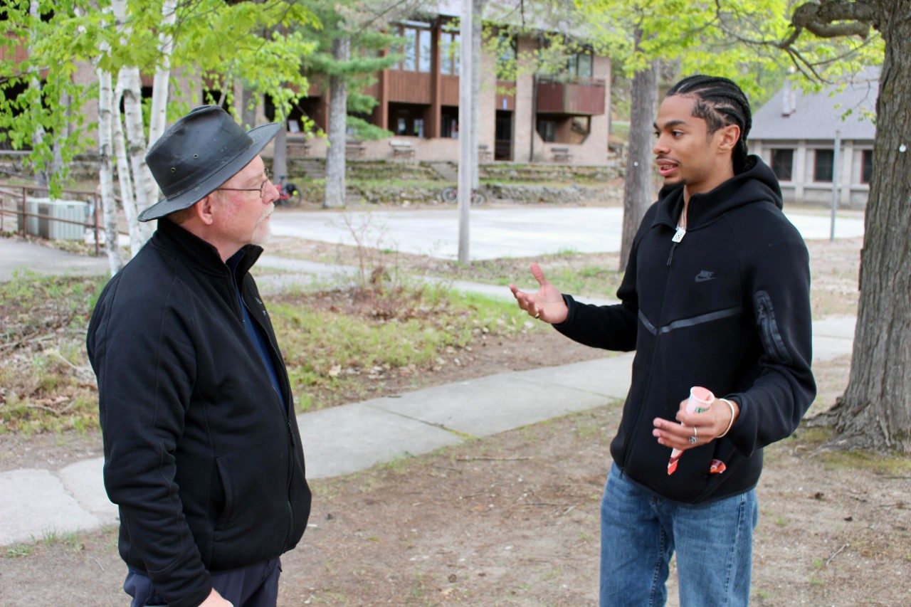 Two people having a conversation outside
