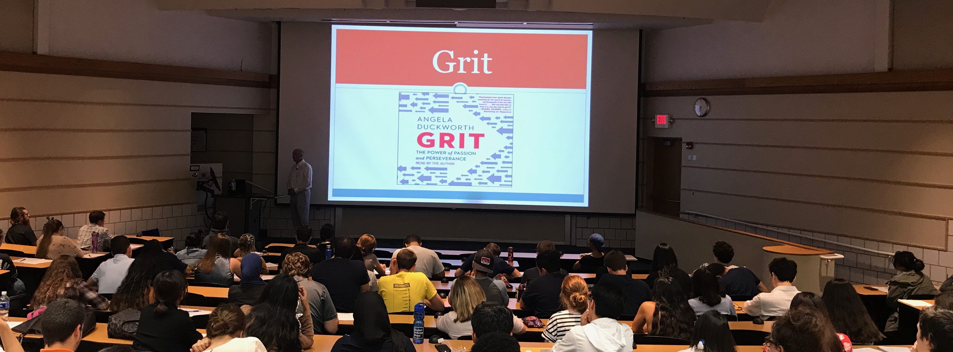 GRIT - Students sitting in multiple tiered rows in a classroom attending a workshop