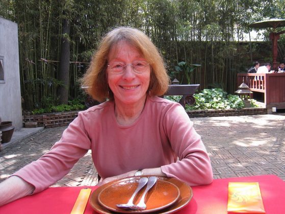 Sonya in a pink shirt at an outdoor table