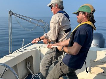 Lifting the deployed subbottom profiler to the deck of the ship.