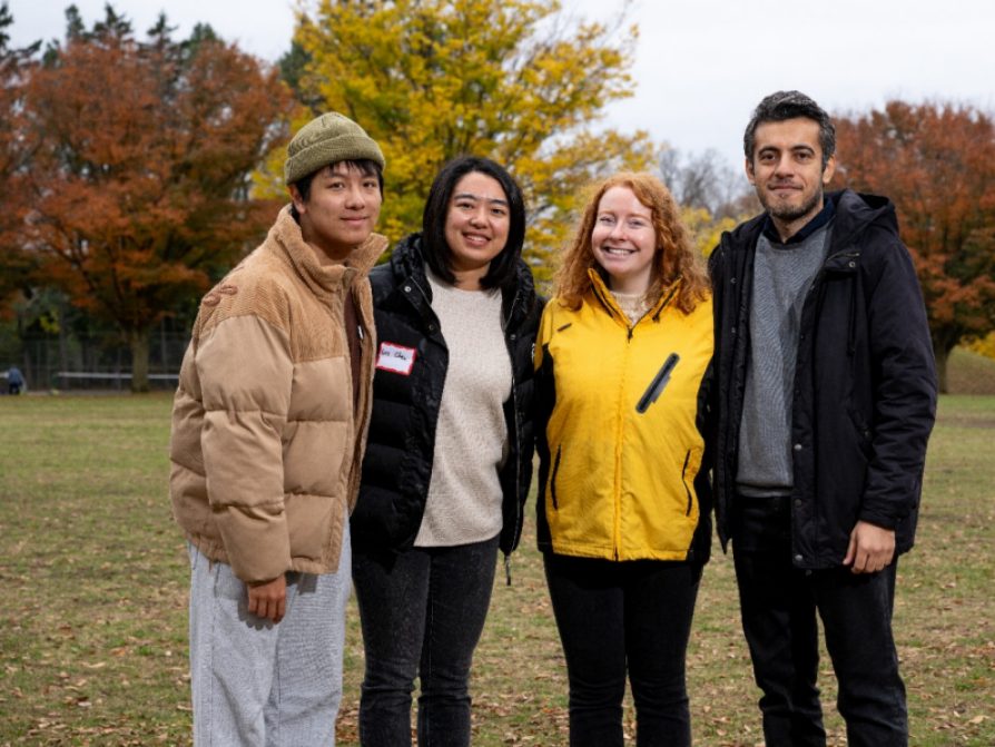 One facilitator and three participants posing for a picture 