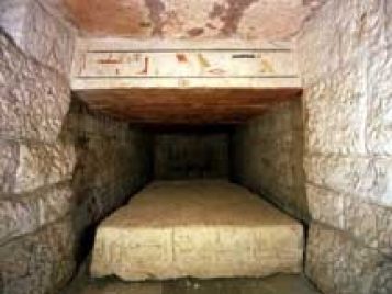 View into burial chamber showing painted interior lintel and inscribed coffin lid.