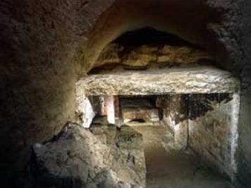 View into an underground chamber constructed of limestone blocks.