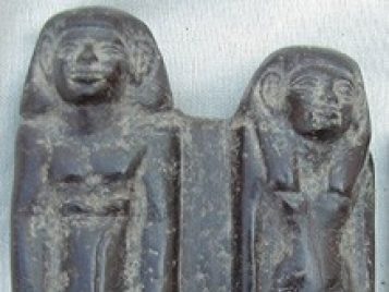 Basalt statue of Intef and Ita, who stand side by side, barefoot, with their arms at their sides.