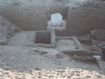 View looking down over the uncovered remains of Weni the Elder's mastaba tomb, consisting of stacked stones.