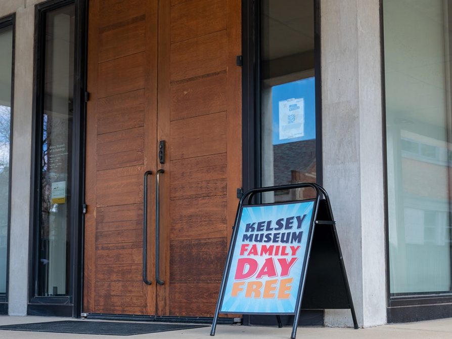 A sign outside the Kelsey Museum’s galleries reading, “Kelsey Museum, Family Day, Free.”