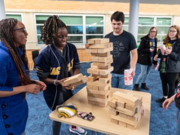 Students playing a game with blocks in the new LSA Building addition.