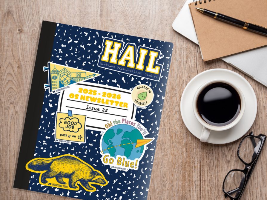 Mockup image of 2025-2026 OS Newsletter notebook style cover laying on a desk with a laptop. notebook, pen, and cup of coffee next to it. 