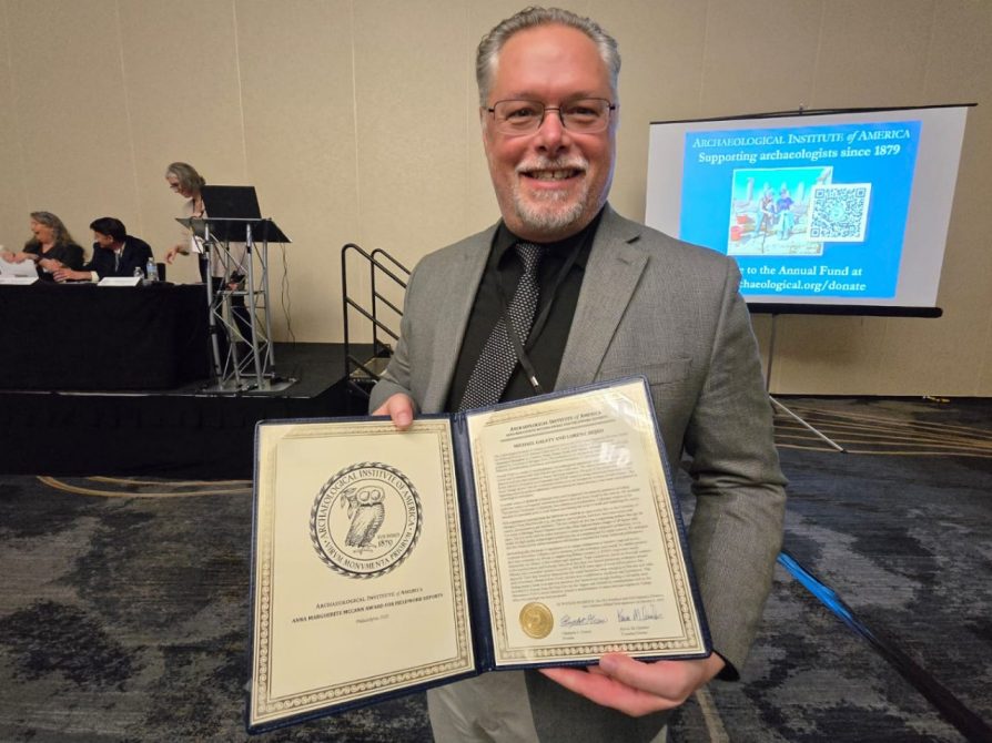 Museum director Michael Galaty accepts book prize at AIA conference 