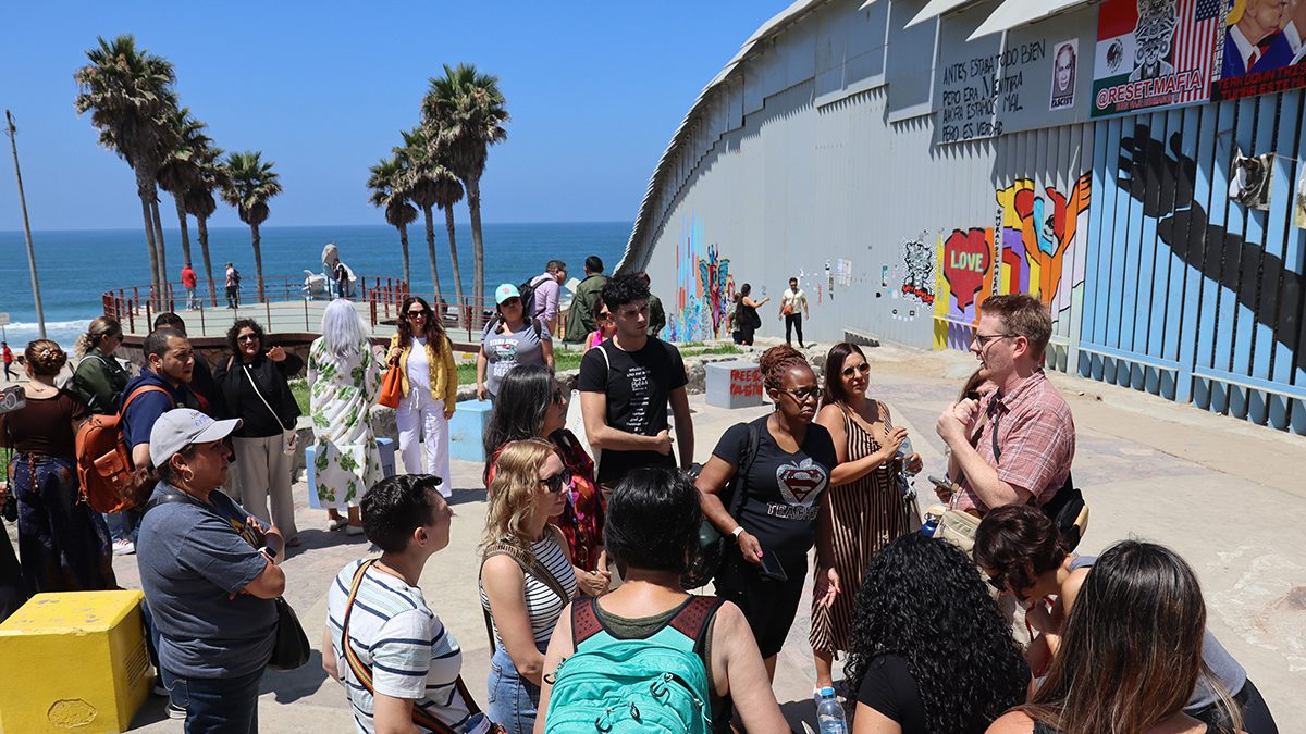 Participants of the GMEI in discussion at the US/Mexico border in Tijuana.