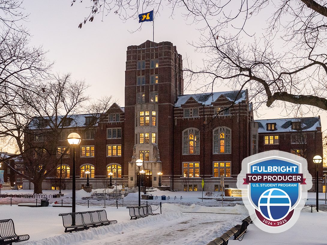 The University of Michigan's Michigan Union building at dusk, with snow on the ground and a Fulbright Top Producer badge overlay