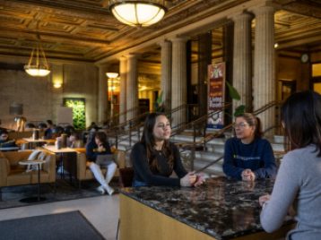 Students and advisor congregate in Angell Hall lobby