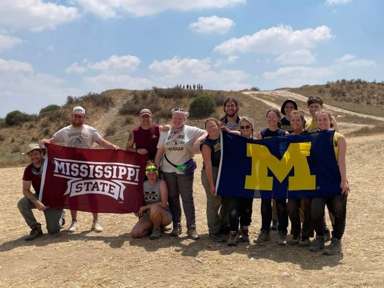 Two teams of researchers each bearing their school's banner. Mississippi State on the left; University of Michigan on the right.
