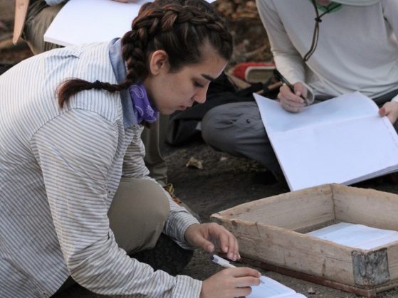 Pruette and a colleague recording data in notebooks at the site.