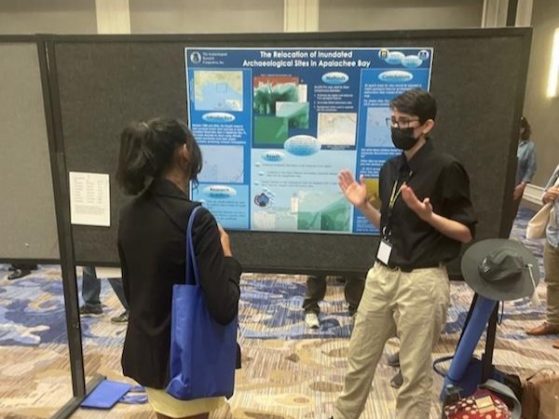 Welch presenting the poster for their honor thesis, “The Relocation of Inundated Archaeological Sites in Apalachee Bay,” at the Society for American Archaeology conference in New Orleans, LA in April 2024.