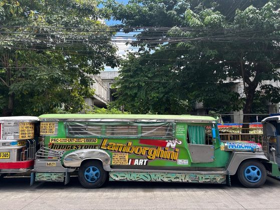 Side view of bright green bus with Bridgestone, Lamborghini, Art and some other text too small to read.