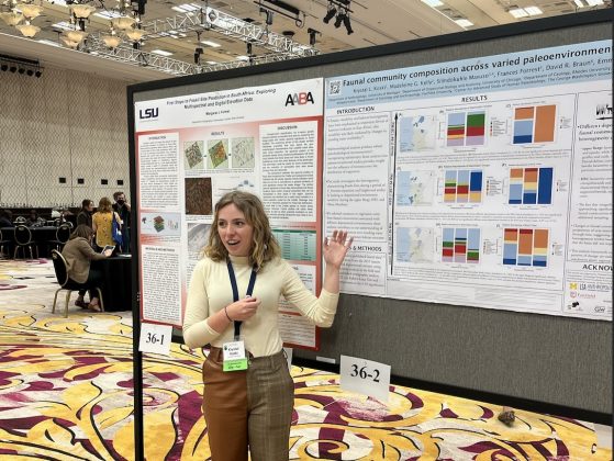 Koski on the exhibition floor talking about her poster, "Faunal community composition across varied paleoenvironmental contexts.