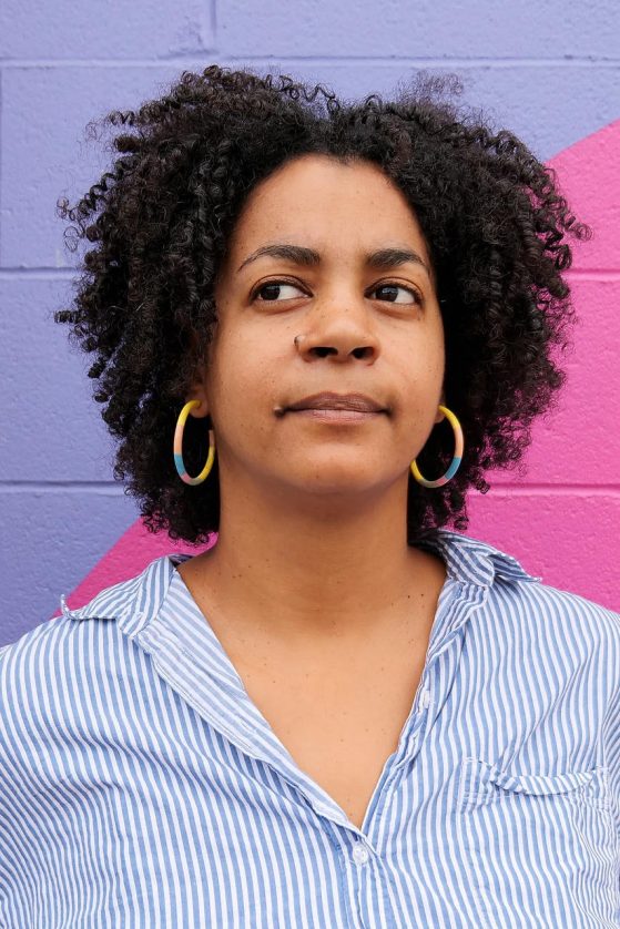 Aisha Sabatini Sloan in front of a pink and purple wall