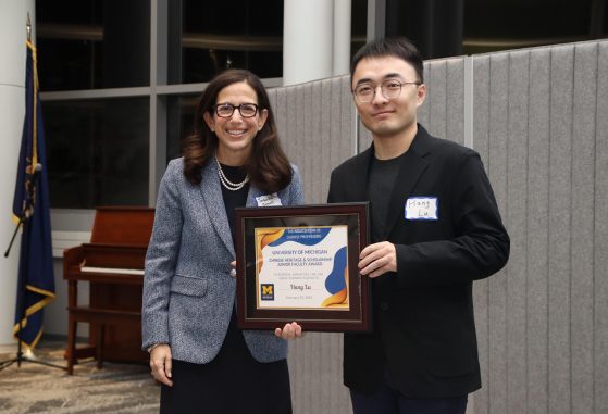 Jacqueline Jeruss and Hang Lu smile with Lu's award