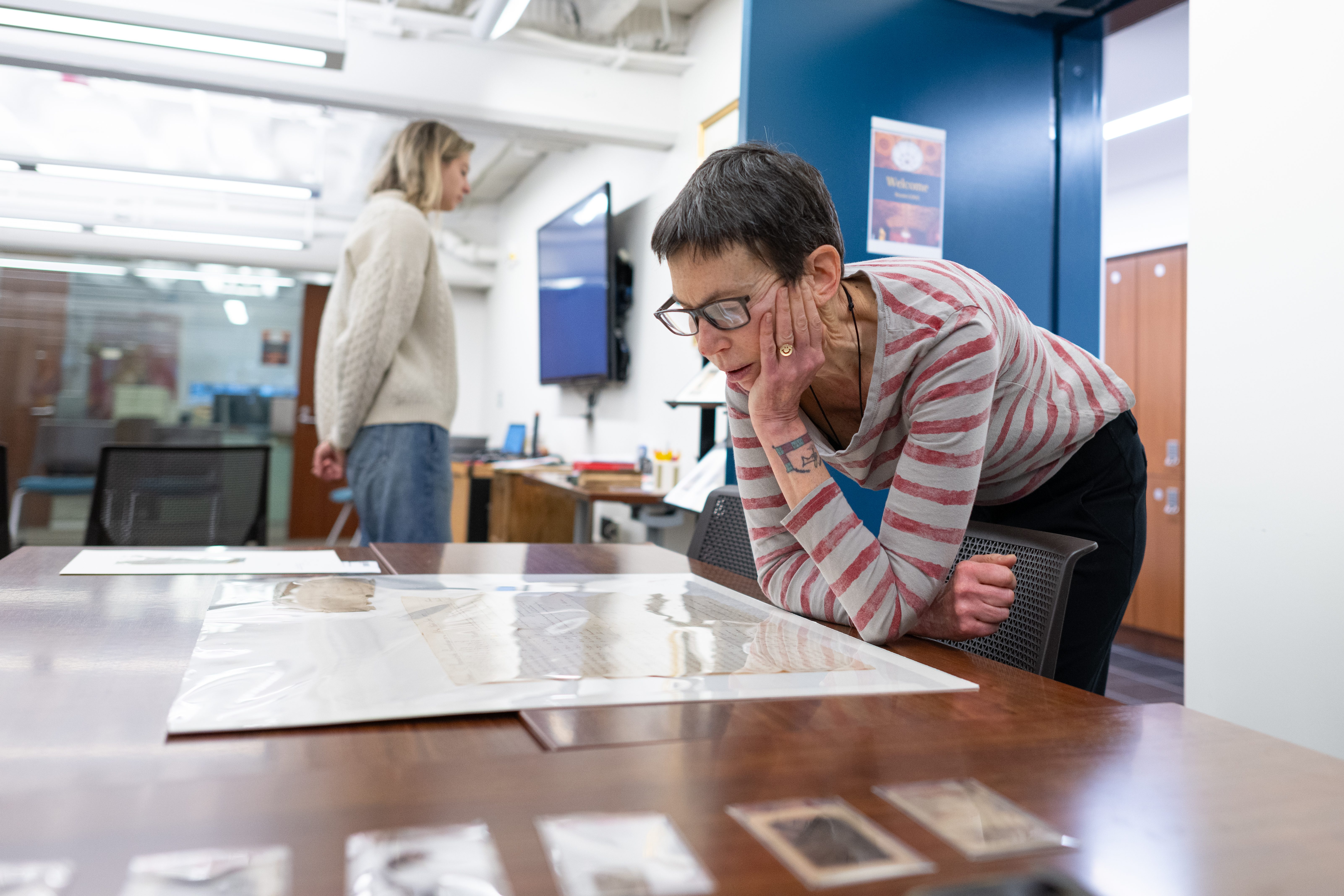 Professor Catherine Brown leaning over a preserved text.