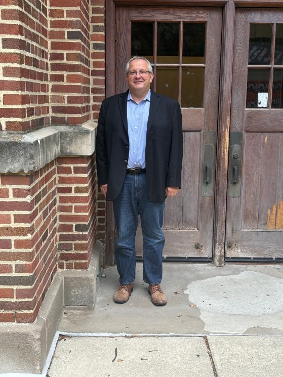 Photo of Rudi Bachmann in front of Lorch Hall