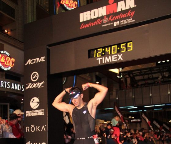 Micheal is pictured finishing an Ironman race.