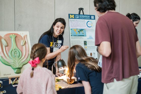 Thais Vasconcelos, associate chair for the Herbarium, shares a specimen with visitors.