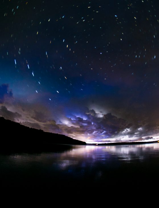 The dark night sky over a body of water