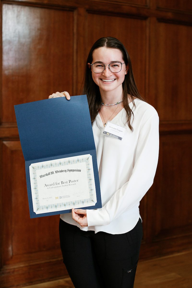 Isabell posing with their award