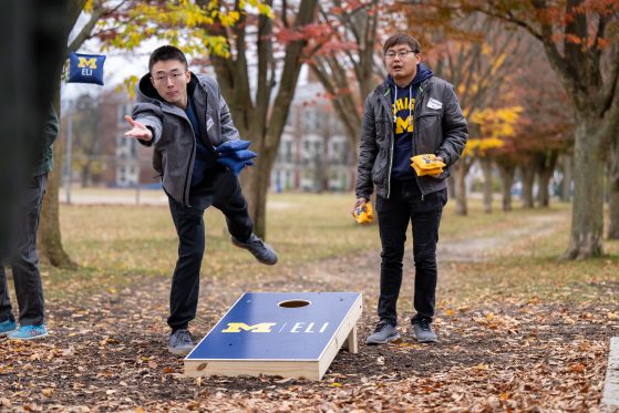 Two participants playing corn holes