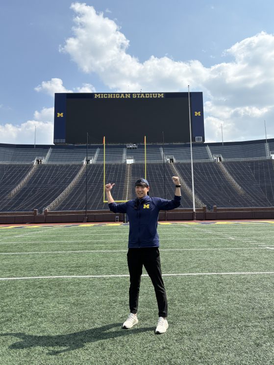 Shuhei standing in the football field 