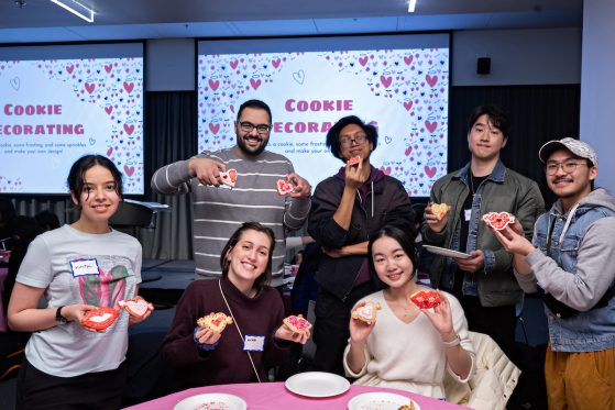 a group of participants holding decorated cookies 