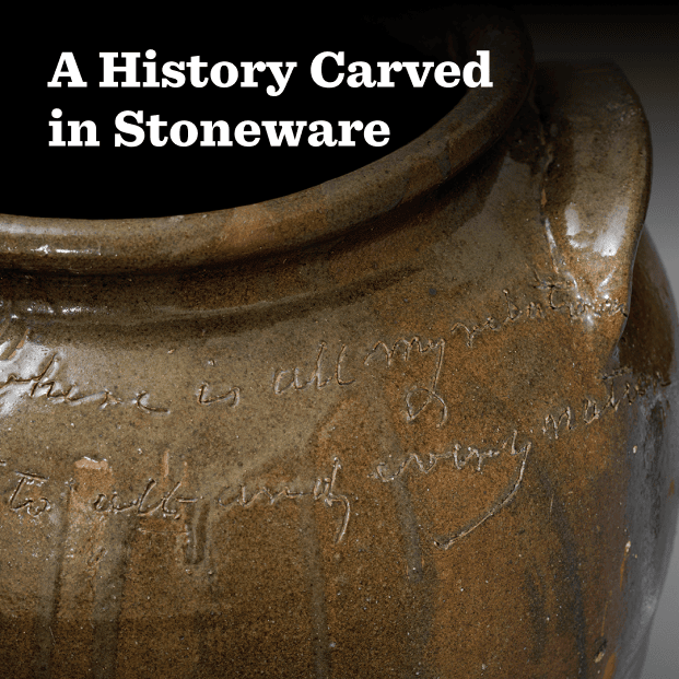 A closeup photo of a large alkaline glazed storage jar created by a potter named Dave. Dave’s handwriting is particularly striking, and his use of cursive is seamless even though his words are written into clay. The jar represents various shades of brown and shines on a gray background. In the foreground this text: A History Carved in Stoneware.