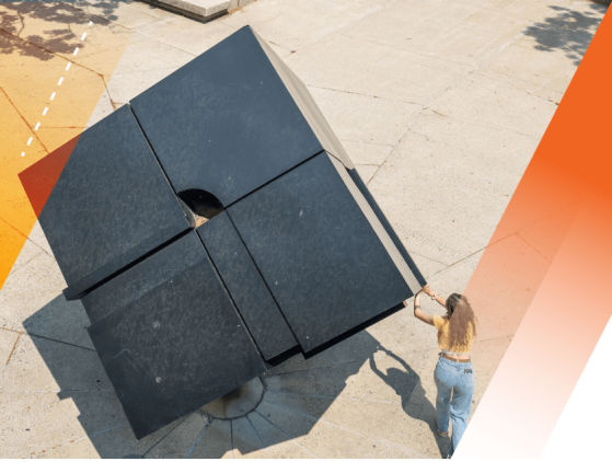 An aerial view of a student with extended arms spinning the Cube.