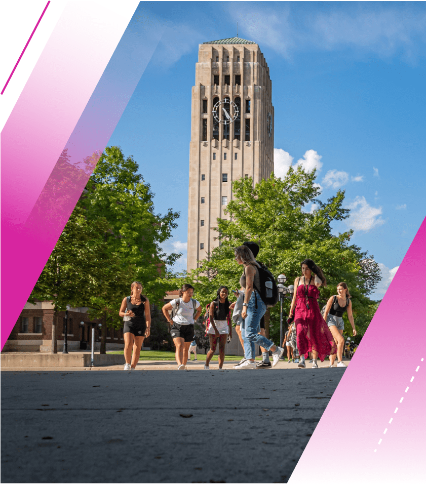 A number of students are pictured walking on Ann Arbor’s central campus. It is a beautiful day and blue skies frame Burton Tower in the background.