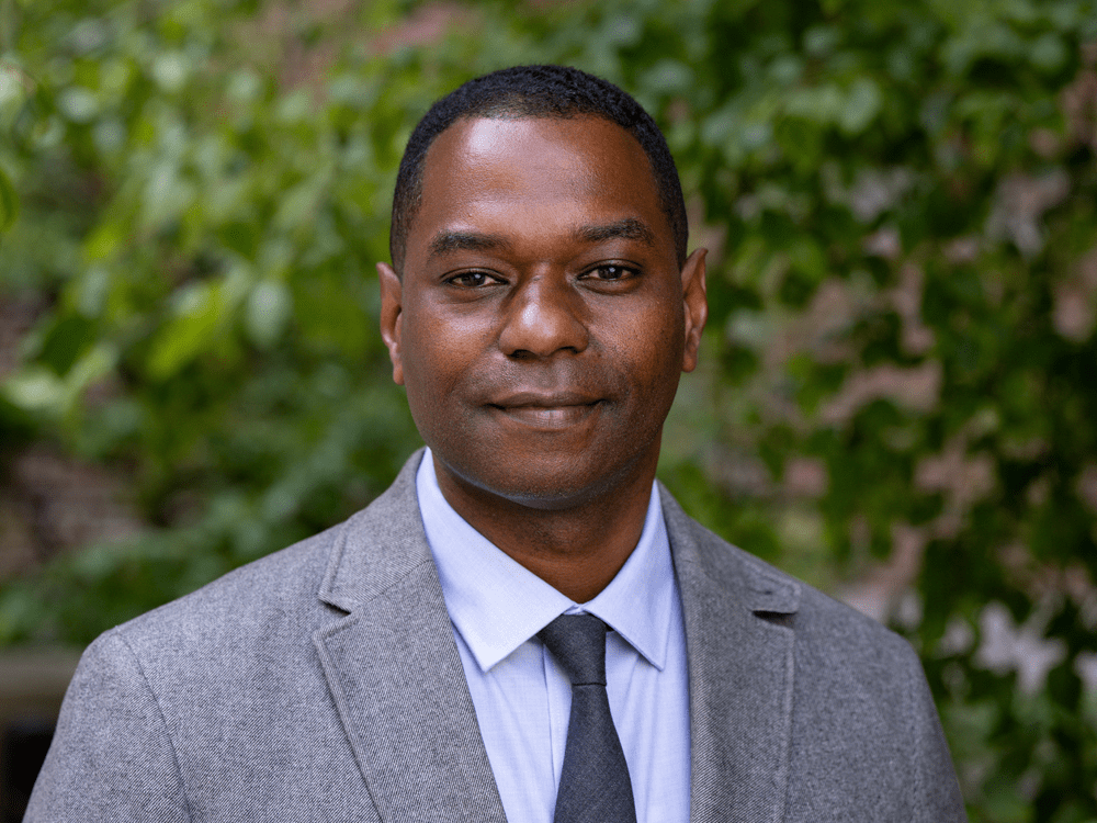 Image of the face and shoulders of Jason Young, who is wearing a gray blazer and tie with a white shirt.