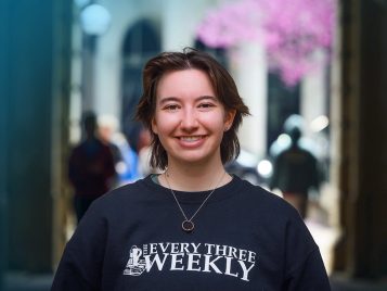 A person wearing a shirt that says "Every Three Weekly" smiles directly at the camera.