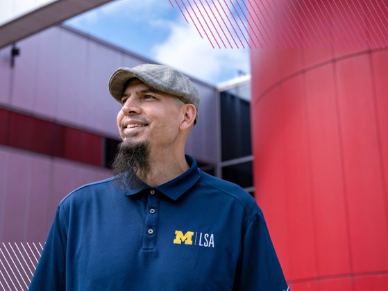 Justin Villanueva stands in front of a building at Henry Ford College in Dearborn, MI.