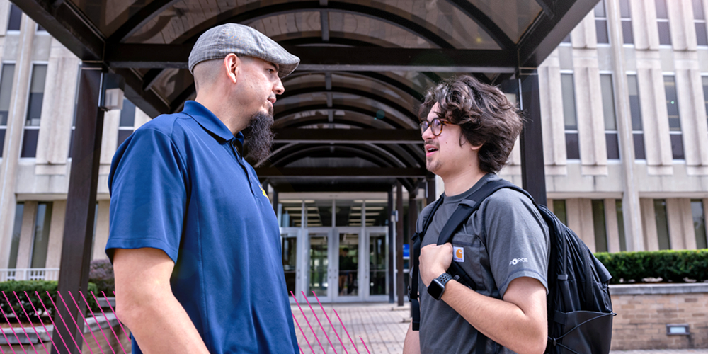 Justin Villanueva talks with a student.