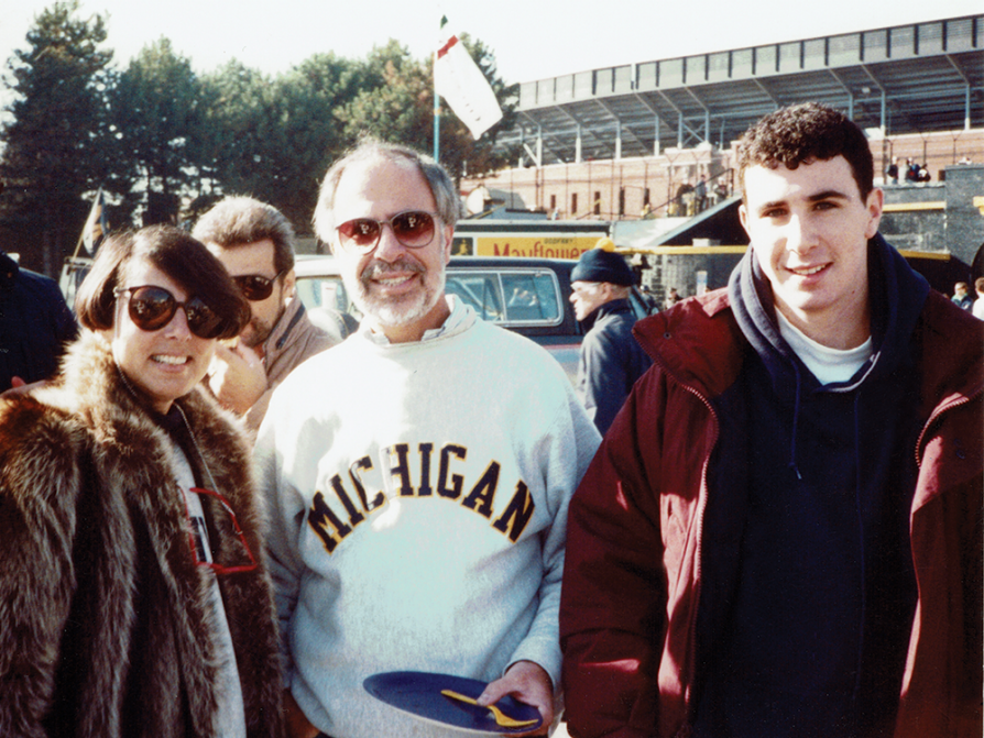 Jonathan Chait with his parents at a Michigan football game