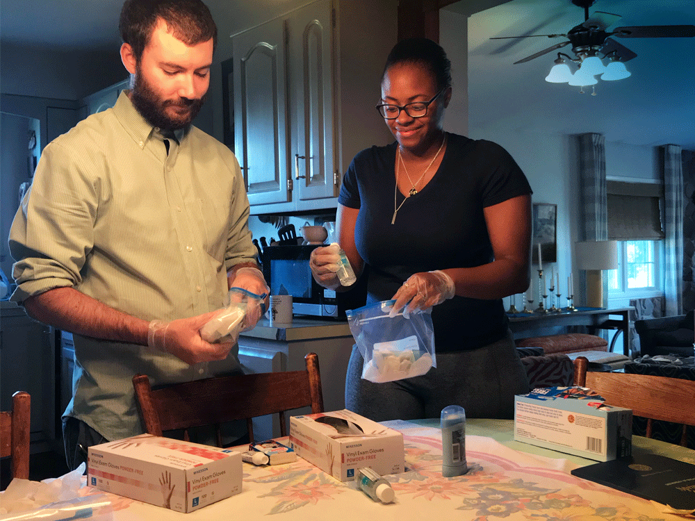 LSA alumna Davon Smith (right) with her fiancé assembling self-care kits including gloves, sanitizer, and masks for Ann Arbor homeless. 
