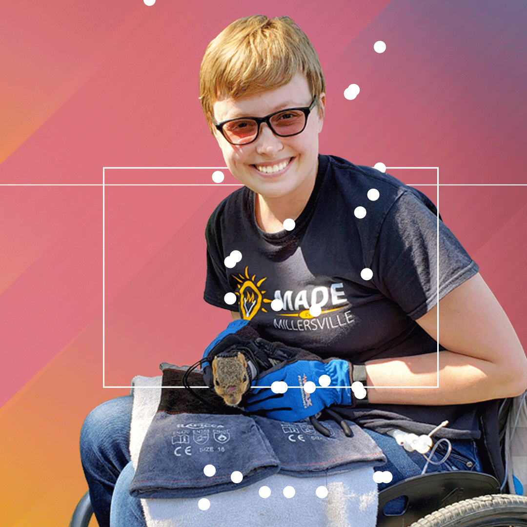 Photograph of Charlotte Devitz holding a squirrel while doing research