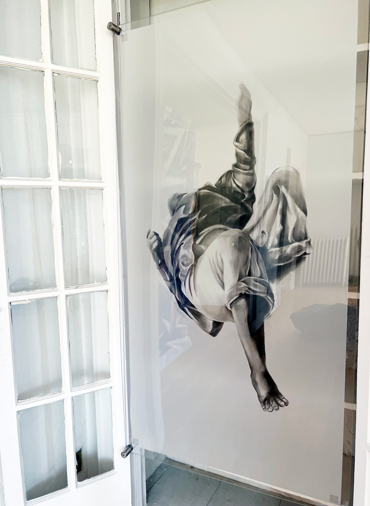 A photograph of a propaganda battleground image reimagined by Francis Estrada into a new work of art. A black and white image of a man lying down in physical defeat has been turned on its side so that the figure appears to be floating.