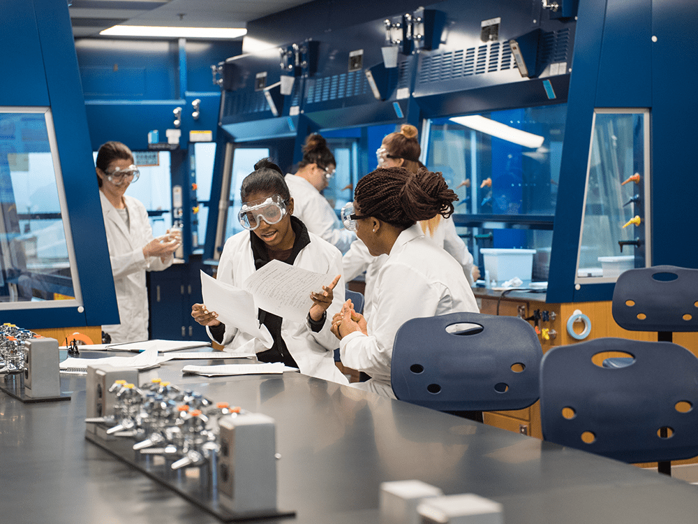 Two undergraduates work on an experiment together in a campus laboratory.
