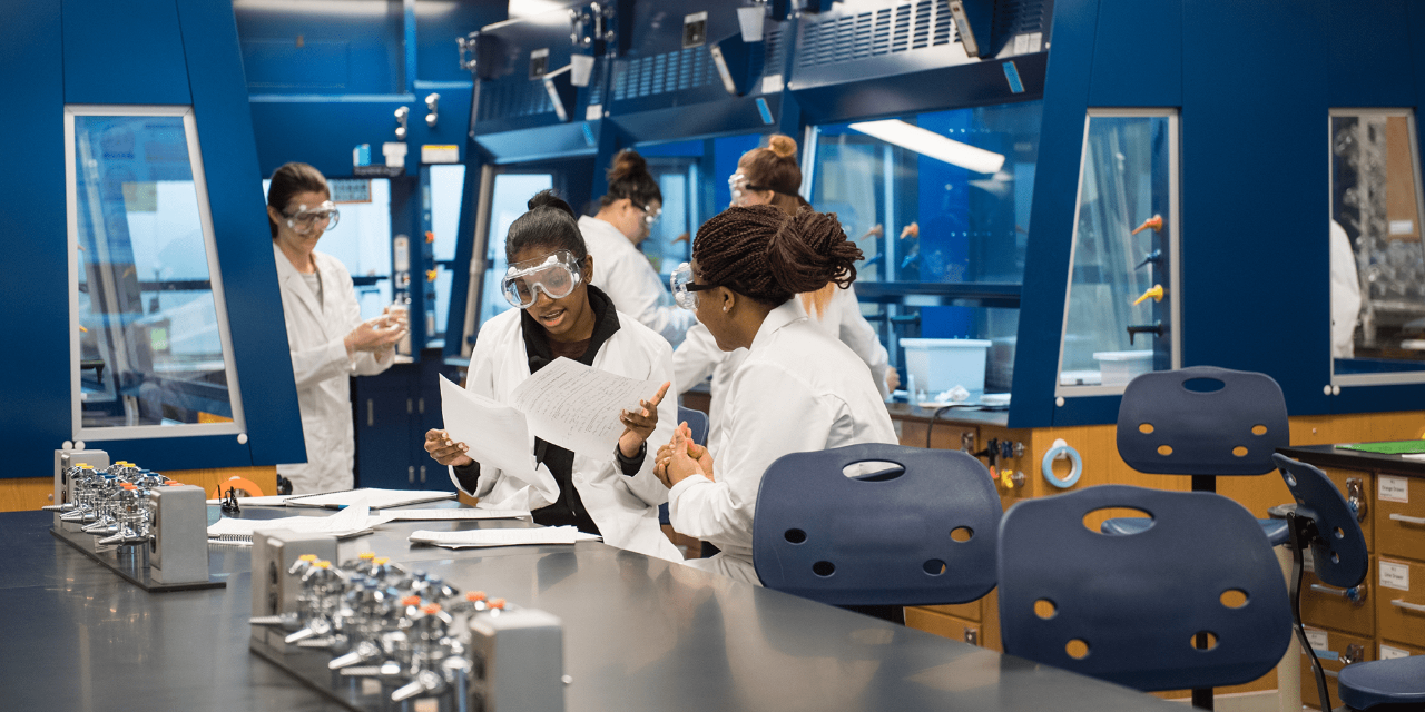 Two undergraduates work on an experiment together in a campus laboratory. This photo was taken prior to the pandemic and COVID-19 social distancing guidelines and mask requirements. 