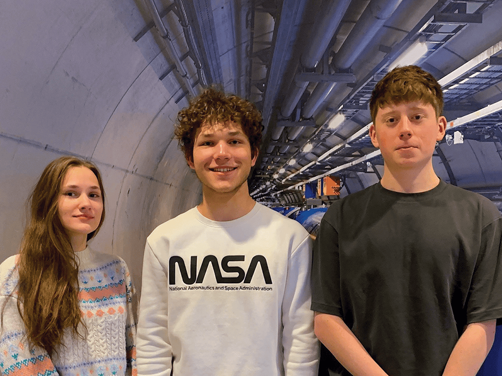 Alum Chad Machinski stands with a tree and a chainsaw in The Arb