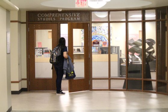 A student is pictured walking through the double doors of CSP's on-campus office, pre-COVID.