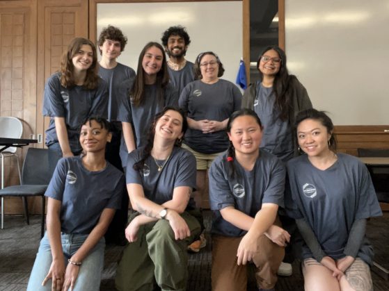 Ten AUGMENT students pose for a group photo in a Union meeting room. They wear matching dark grey t-shirts with the AUGMENT logo.