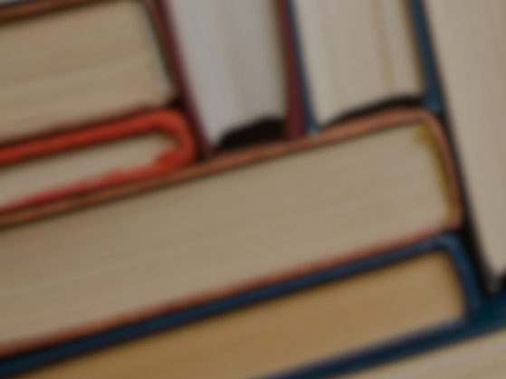 several books standing on end, side-by-side, viewed from above