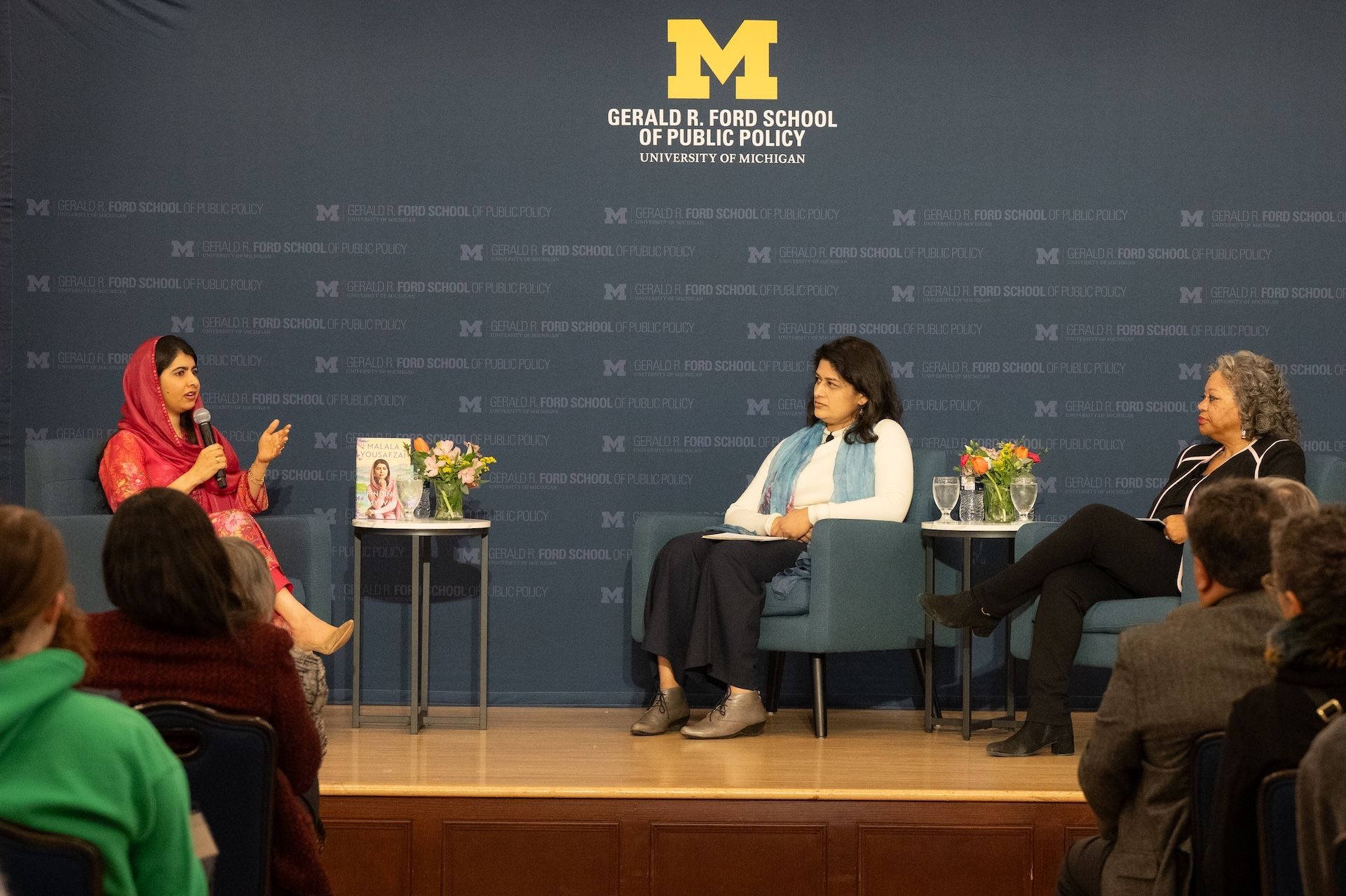 Three women on stage in conversation